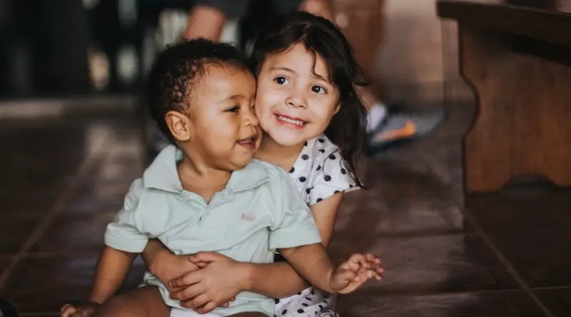 Brother and sister playing on the floot