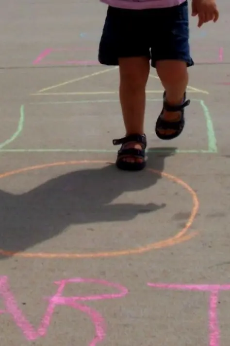 girl playing on chalk drawings