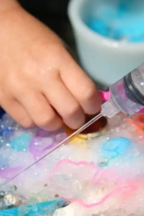 plastic syringe with coloured water