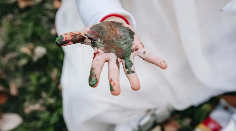 child hand smudged with paint