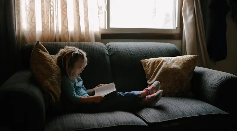 Girl reading on a couch