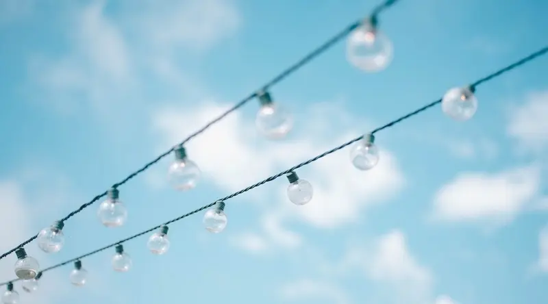 A string of lights against a cloudy blue sky