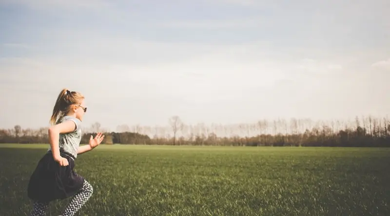 Girl running outdoors on a field