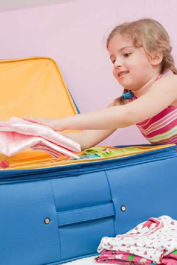A girl packing a suitcase