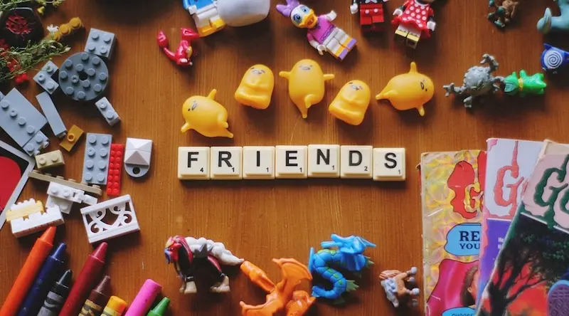 Toys spilled around cubes with Friends written on them