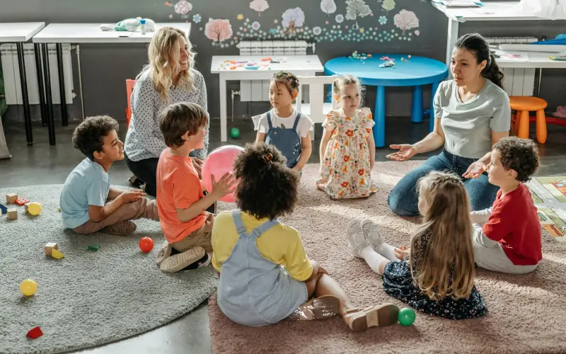two preschool teachers in circle time with the kids