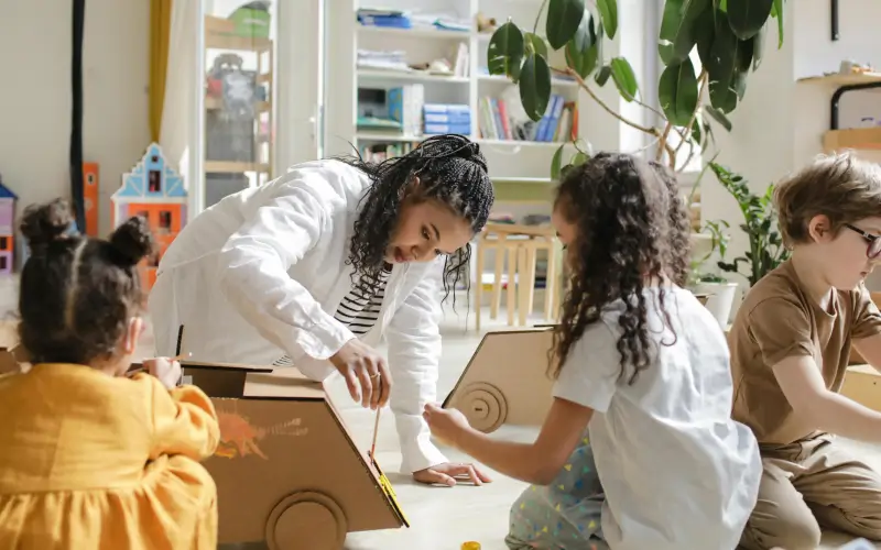preschool teacher engaging with the children in the classroom