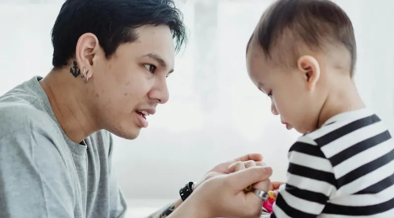 teacher consoling a little boy