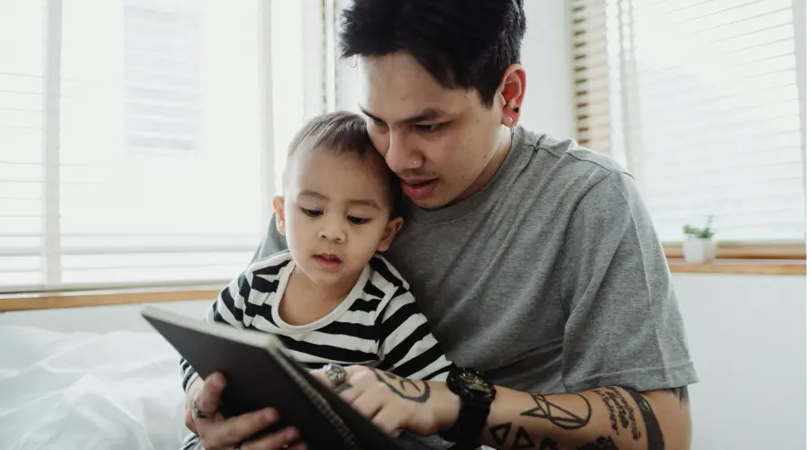 parent reading to his young son