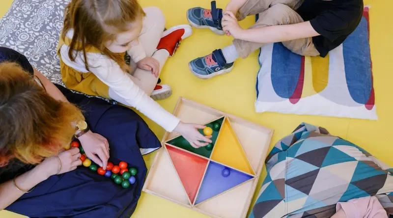 kids playing games on the floor at preschool