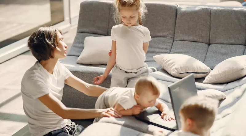 mom playing with her three young children