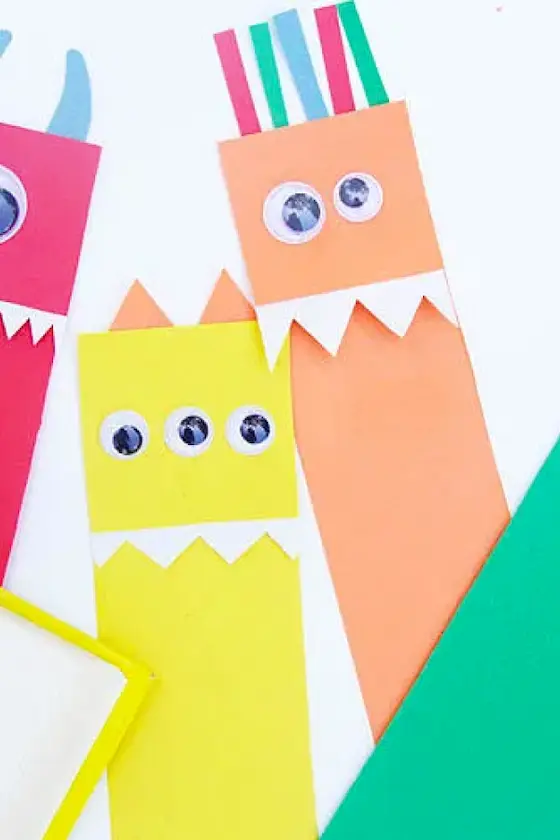 Colorful paper cutout monsters with googly eyes