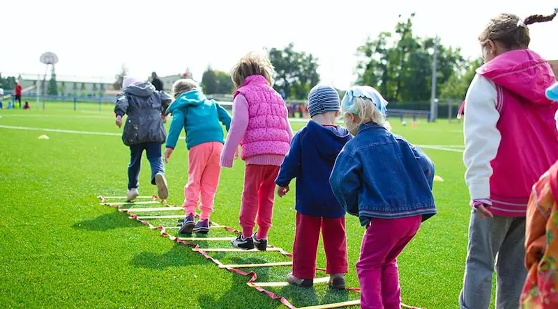 kids playing outdoors on a soccer field