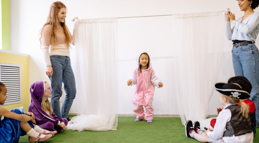 nursery setting with teachers playing with kids