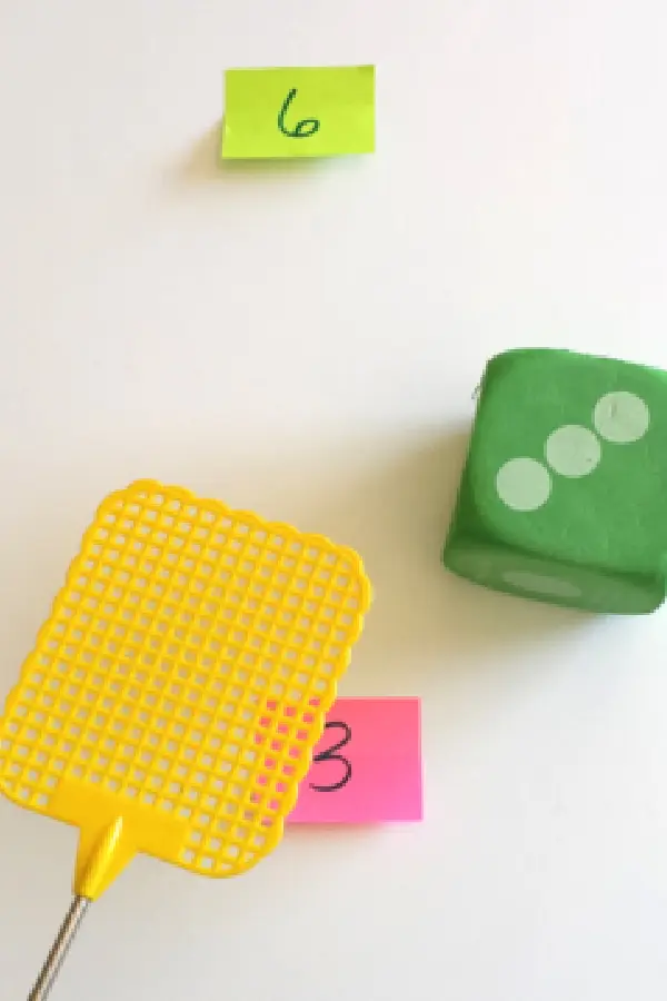 Green die and sticky notes with numbers on