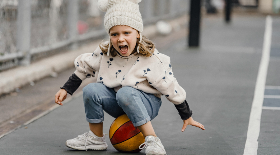 a young girl upset on the playground