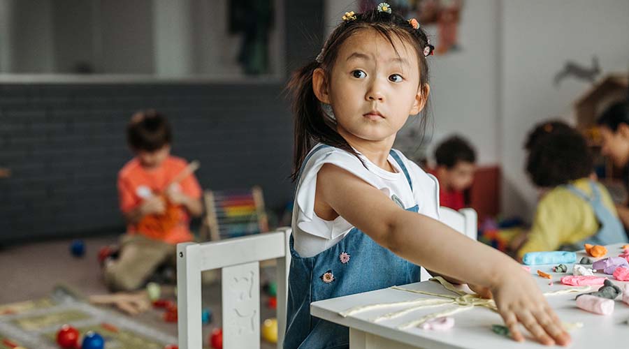 Making mistakes is part of learning in early education. A child plays with craft materials at a table