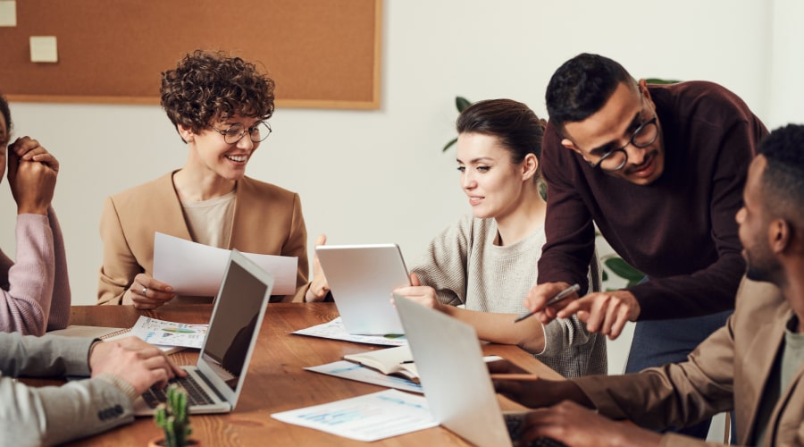 Group of people gathered around wooden table