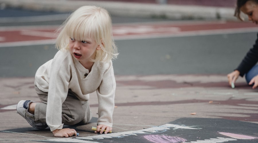 Emotional girl on ground looking away
