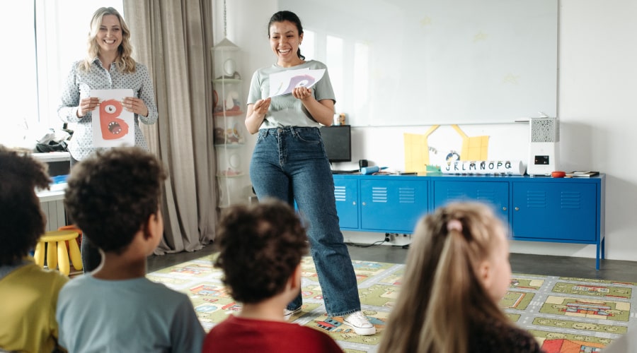 Women standing in front of children