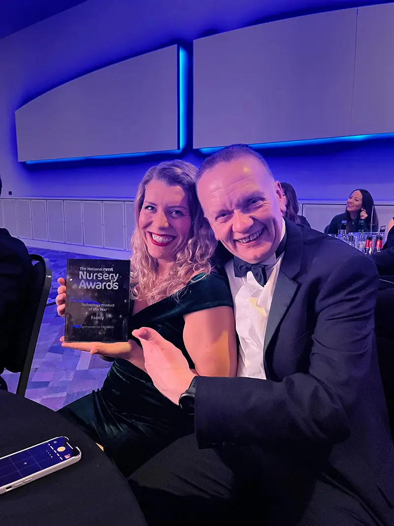 Famly colleagues Kim and Alan hold the NMT award trophy at the ceremony.