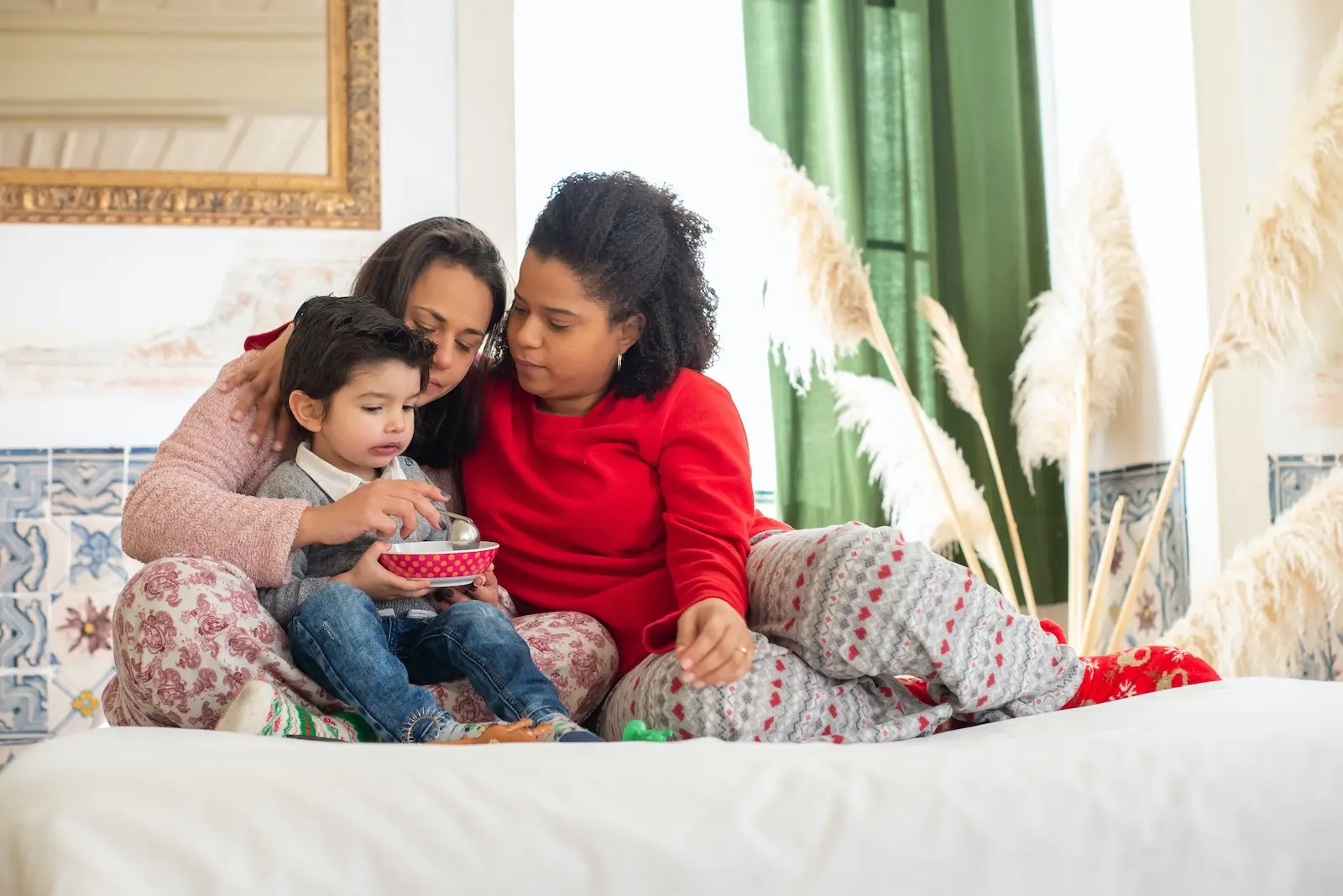 A non heteronormative couple relaxing with their child