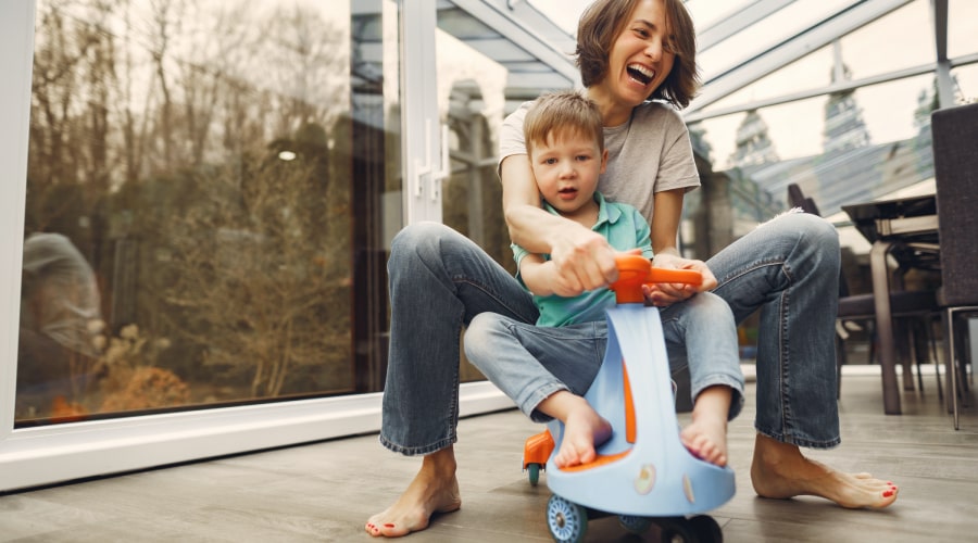 Mother and son barefoot riding a twist car