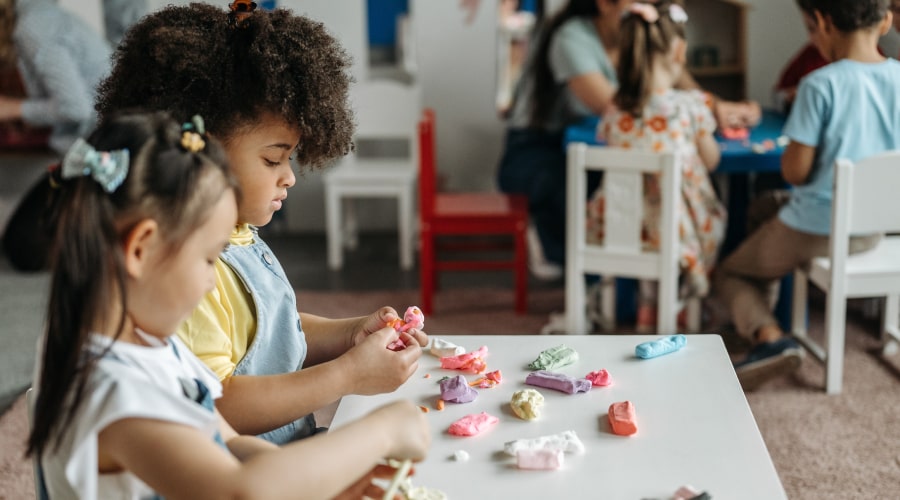 Girls playing with plasticine