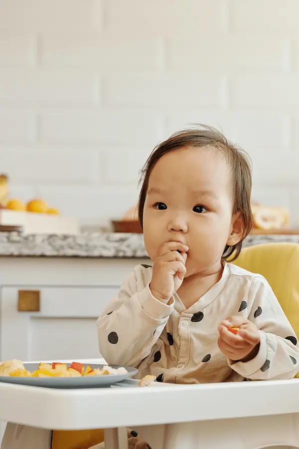 Little girl eating fruits