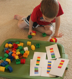 Boy playing with Lego bricks