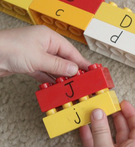 Kid's hands holding Lego bricks