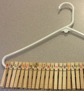 Picture of a white hanger with clothes pegs