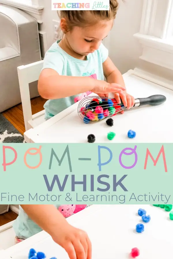 Little girl playing with pom-pom whisk