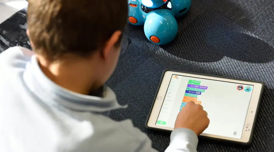 young boy learning on an ipad