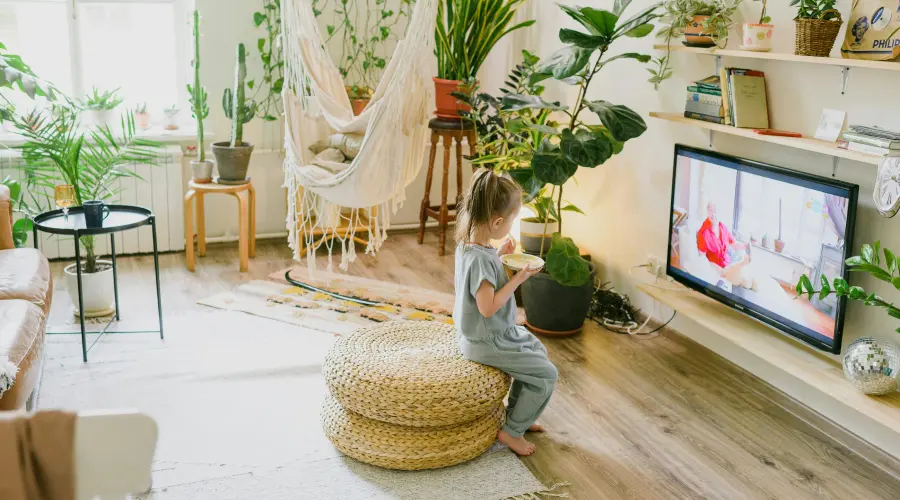 young girl eating and watching tv
