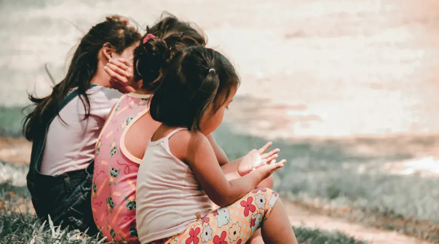 three young kids sitting together