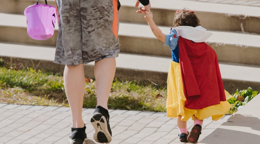 preschooler dressed up as snow white holding parents hand