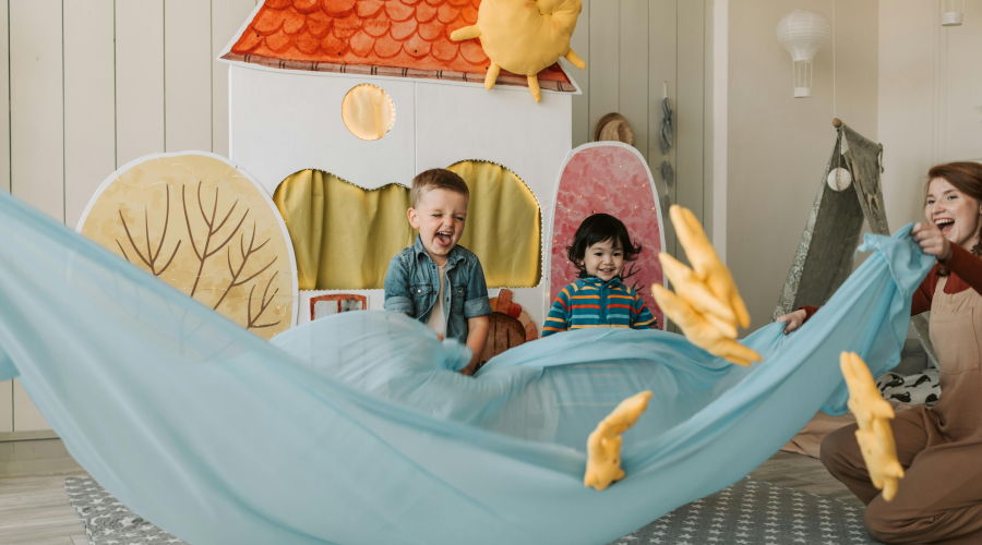 preschoolers playing with a parachute