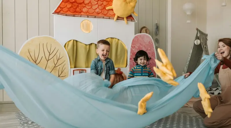 preschool classroom playing with parachute
