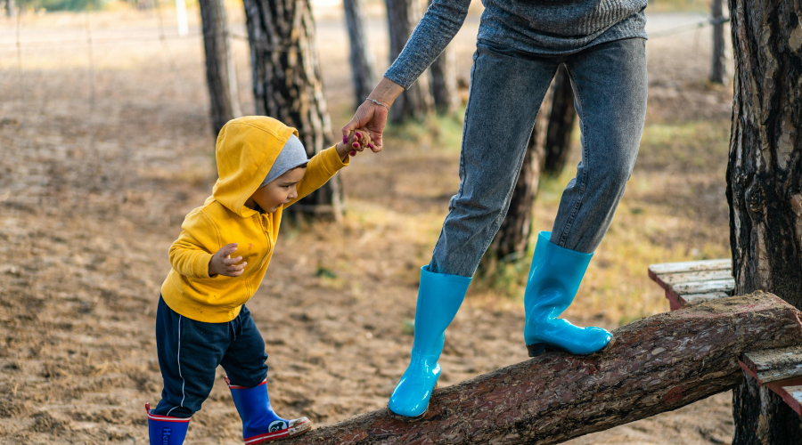 toddler playing outside in the mud