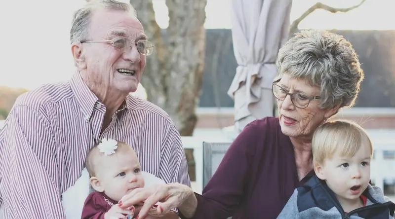 grandparents and two young children posing for a photo
