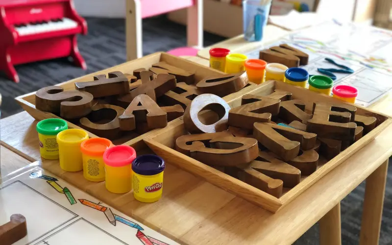Wooden toys and play-doh in a classroom