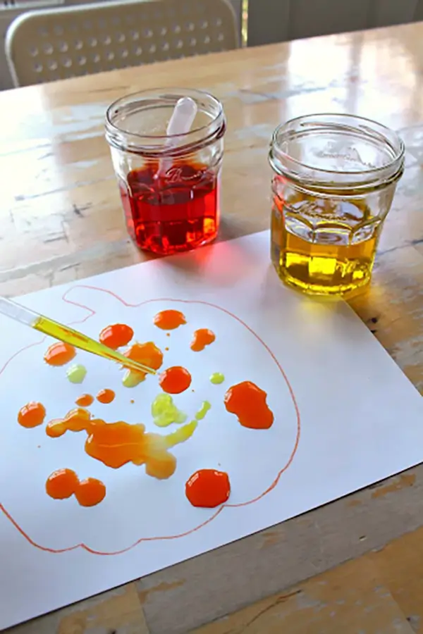 colorful liquids and pipettes on table