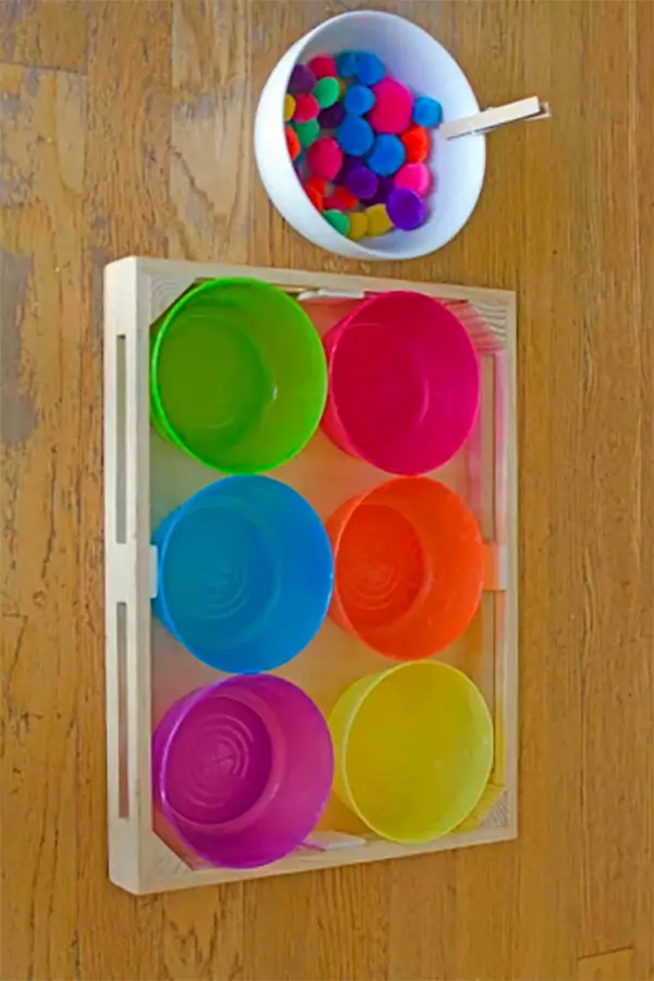 colorful pom-poms and tweezers