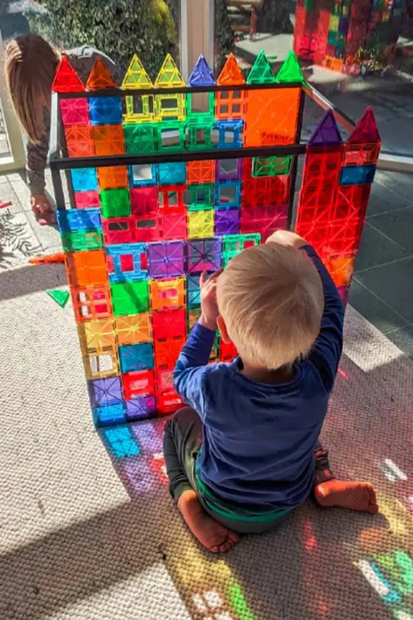 Child playing with a glass castle