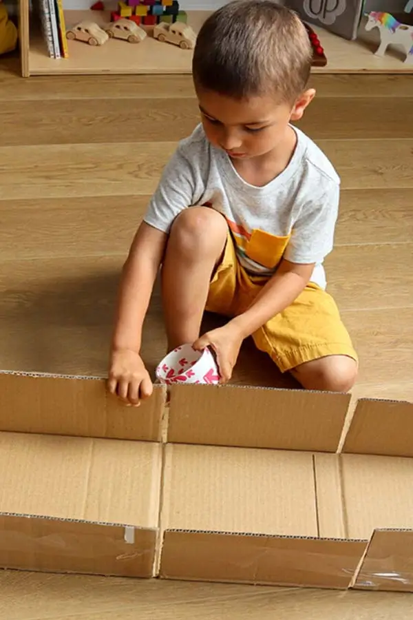 boy playing with cardboard