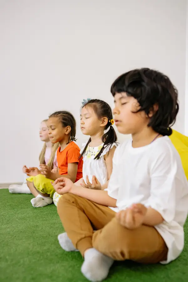 Kids meditating in the lotus pose