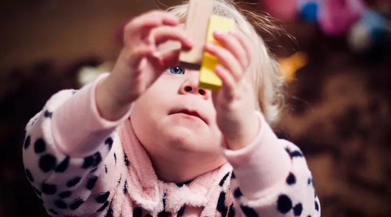 Little girl playing with bricks