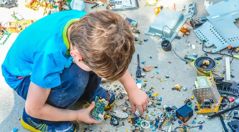 boy builds with lego on ground