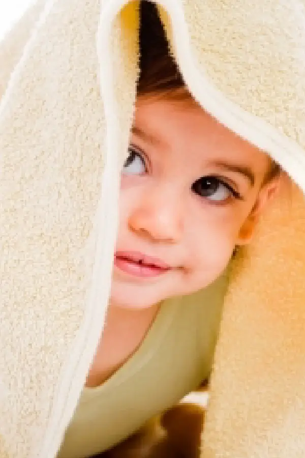 A child hiding under a blanket